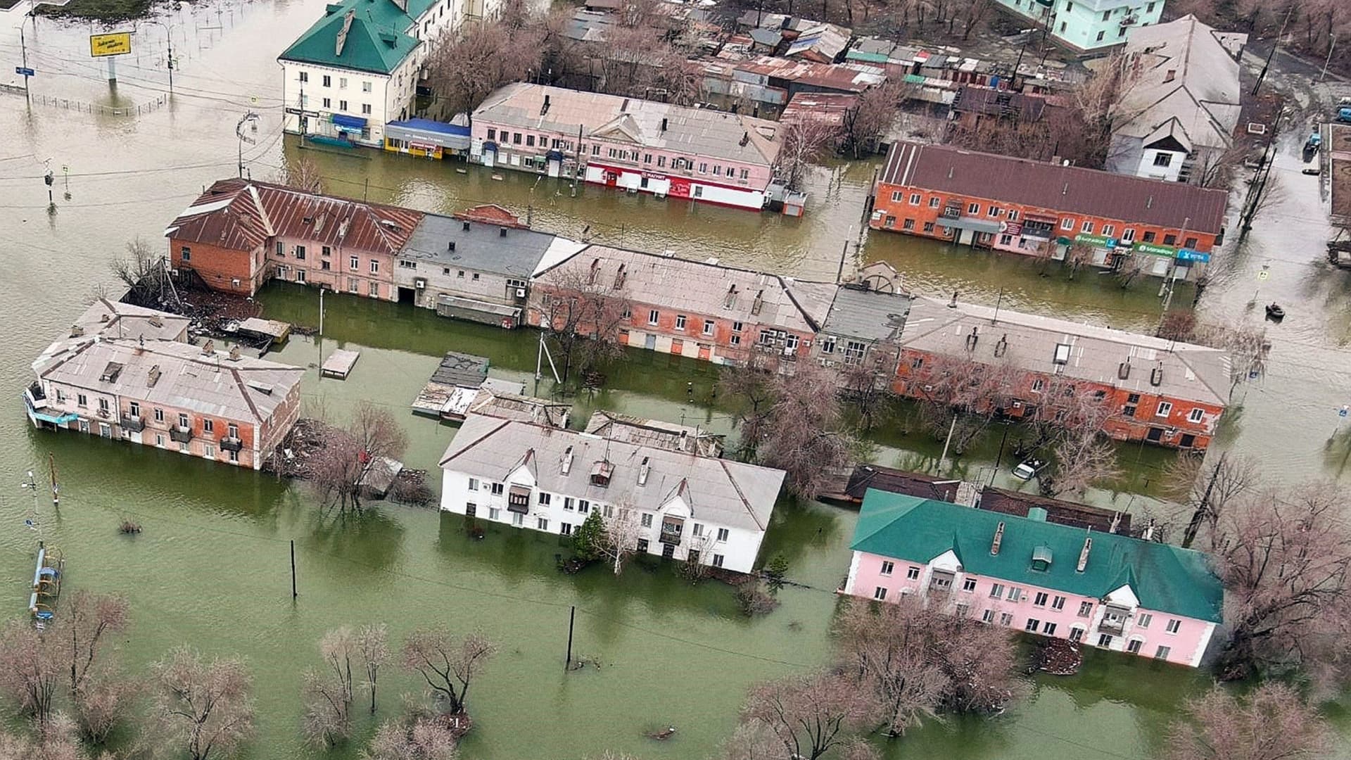 An aerial picture taken on April 8, 2024 shows the flooded part of the city of Orsk, Russia's Orenburg region, southeast of the southern tip of the Ural Mountains. Russia said on April 8, 2024 that more than 10,000 residential buildings were flooded across the Urals, Volga area and western Siberia as emergency services evacuated cities threatened by rising rivers. On April 7, Russia declared a federal emergency in the Orenburg region, where the Ural river flooded much of the city of Orsk and is now reaching dangerous levels in the main city of Orenburg. Much of the city of Orsk has been flooded after torrential rain burst a nearby dam. (Photo by Anatoliy Zhdanov / Kommersant Photo / AFP) / Russia OUT (Photo by ANATOLIY ZHDANOV/Kommersant Photo/AFP via Getty Images)