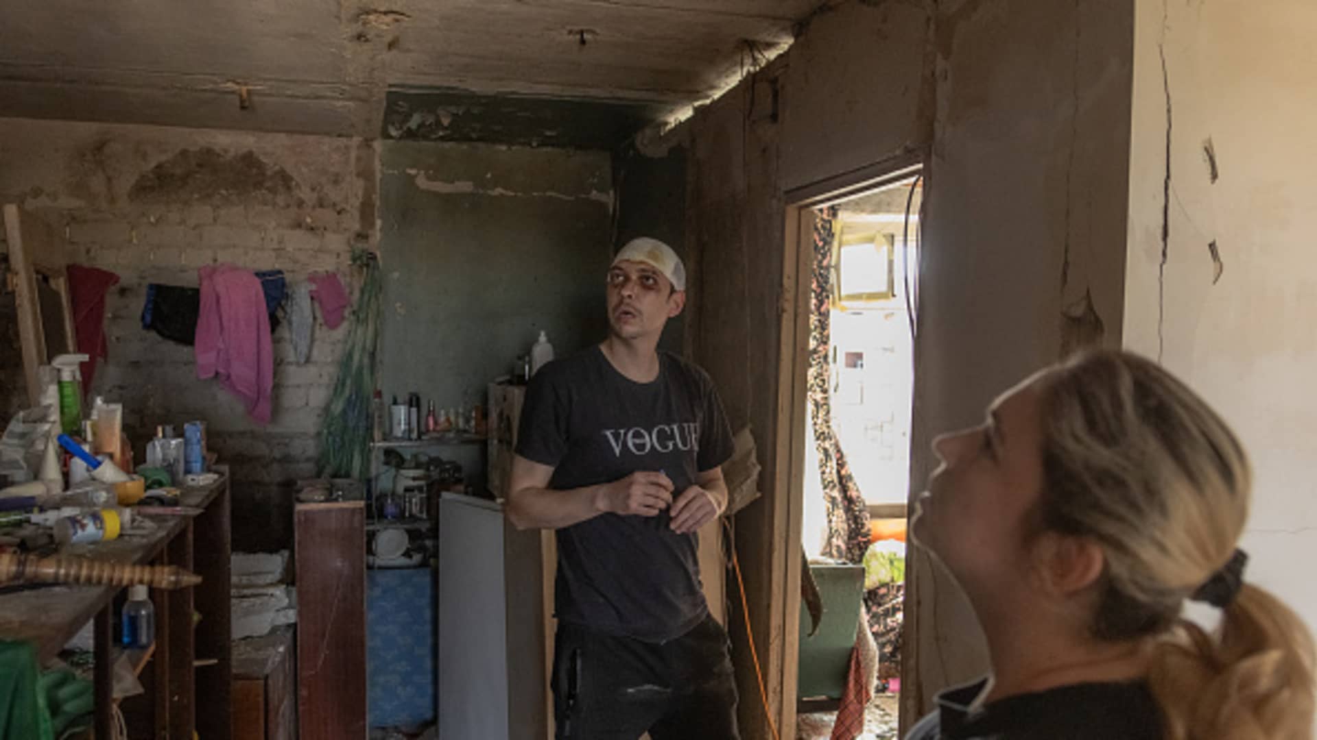 Maksym, 33, (L) and his wife Natasha, 39, visit their apartment that was heavily damaged during a recent Russian attack on the city, in Kharkiv, on April 9, 2024, amid the Russian invasion of Ukraine.