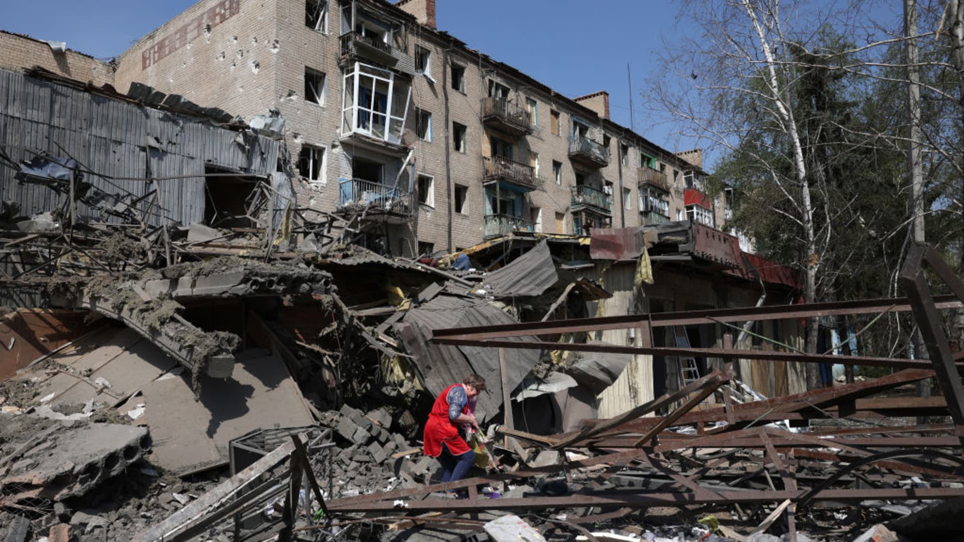 A woman looks through the rubble of a building destroyed by bombing in the town of Kostyantynivka, Donetsk region, on April 11, 2024, amid the Russian invassion in Ukraine. (Photo by Anatolii STEPANOV / AFP) (Photo by ANATOLII STEPANOV/AFP via Getty Images)