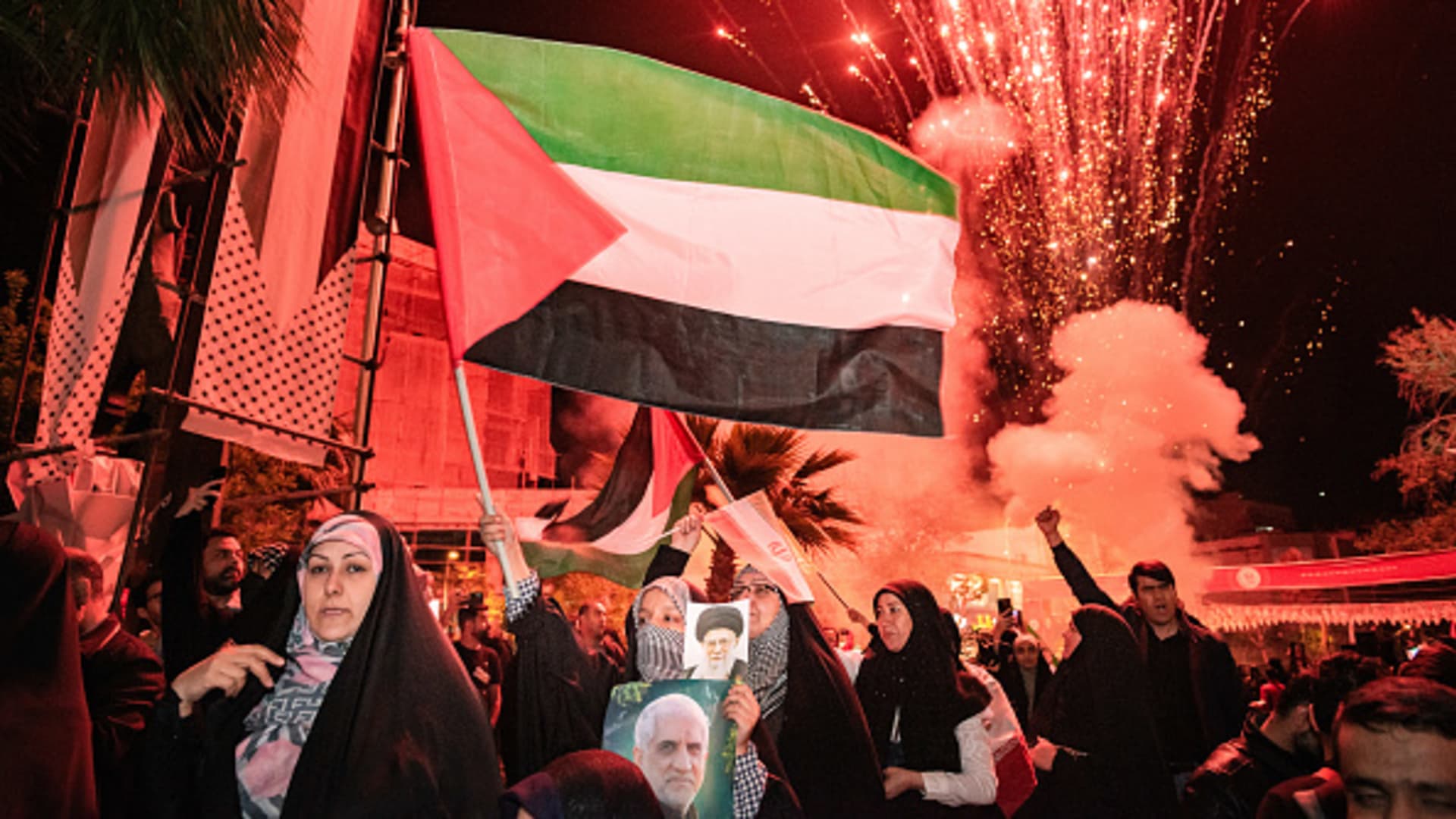Iranian pro-government supporters shout anti-Israel slogans while waving the Palestine flag at Palestine Square in Tehran, on April 14, 2024, in a celebration of the early morning Iran's IRGC attack on Israel.