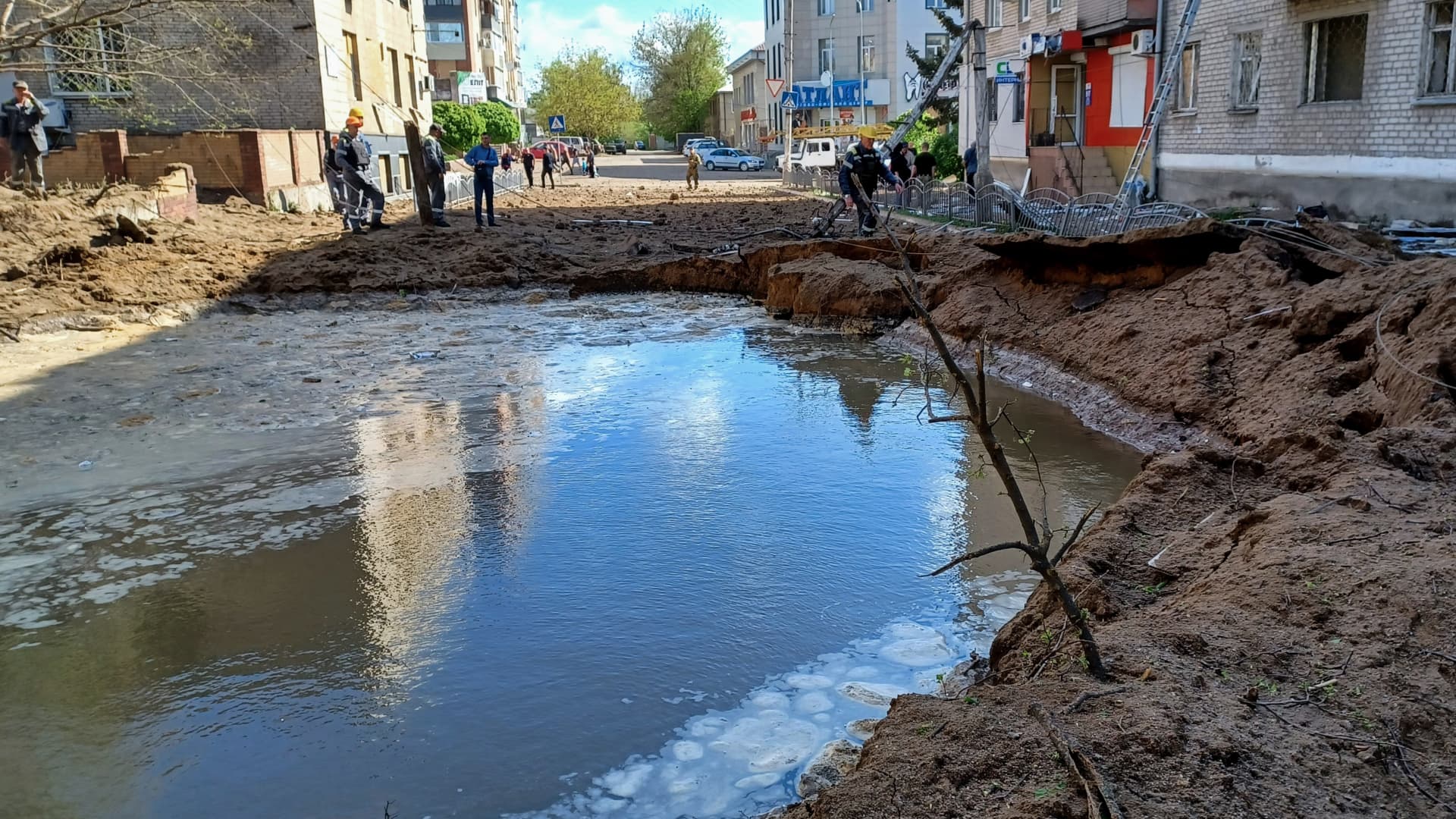 A missile crater near a five-story residential building remains filled with water following water supply pipes' damage on April 15, 2024 in Sloviansk, Donetsk Oblast, Ukraine.