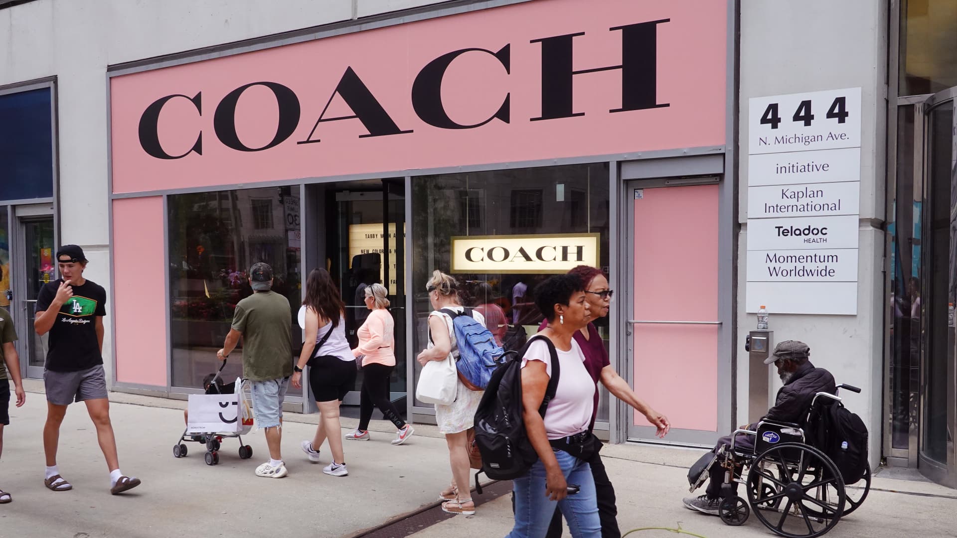 Pedestrians walk past a Coach store on August 10, 2023 in Chicago, Illinois. 
