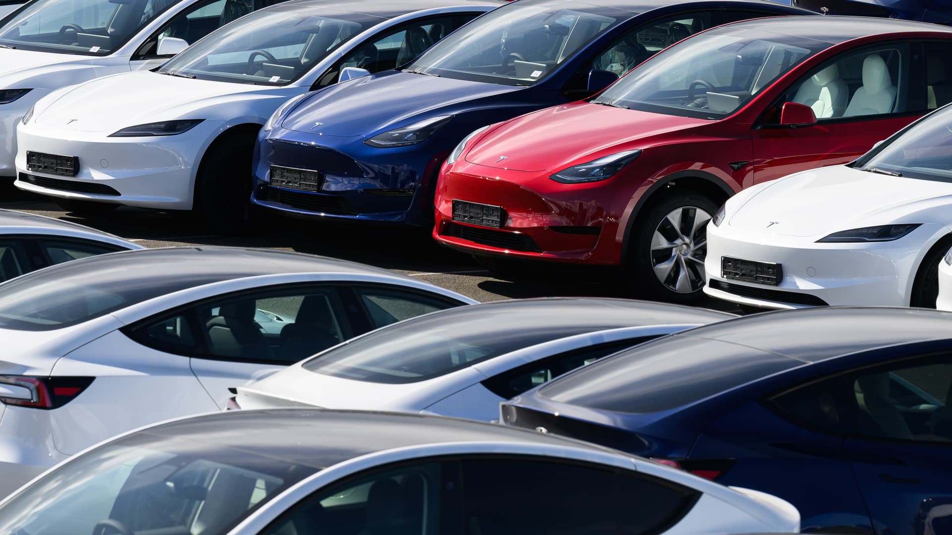 Rows of new Tesla cars are seen in a holding area near a customer collection point on April 15, 2024.
