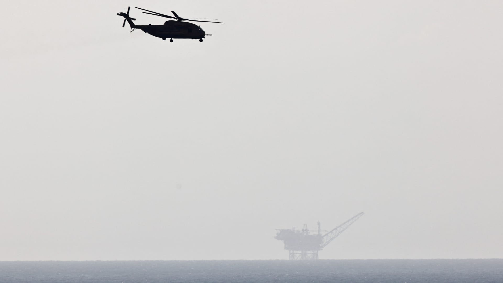 An Israeli Sikorsky helicopter is flying near Ashkelon as an Oil Rig is seen at the background, amid the ongoing conflict between Israel and Palestinian Islamist group Hamas, in Israel, November 14, 2023.