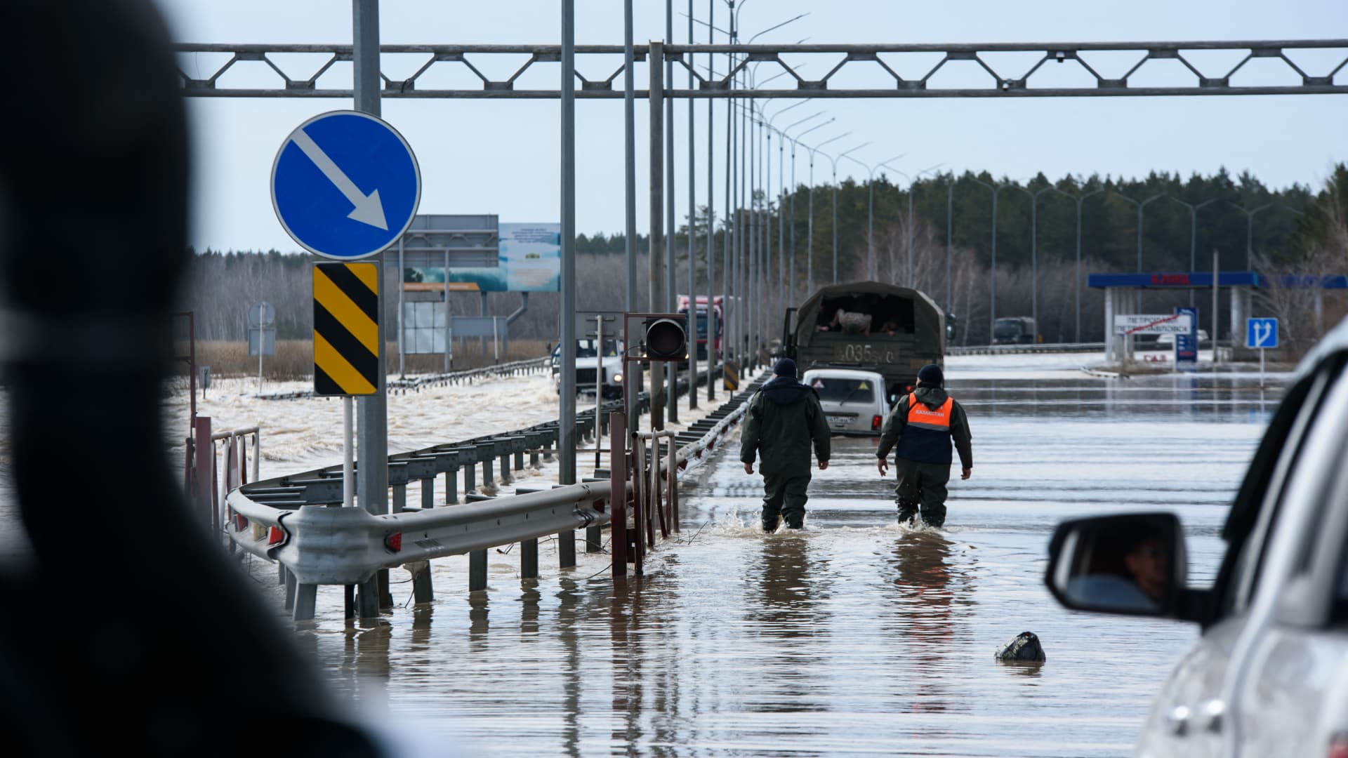 Trucks move through a flooded part of a road in the city of Petropavl in northern Kazakhstan close to the border with Russia on April 14, 2024. 