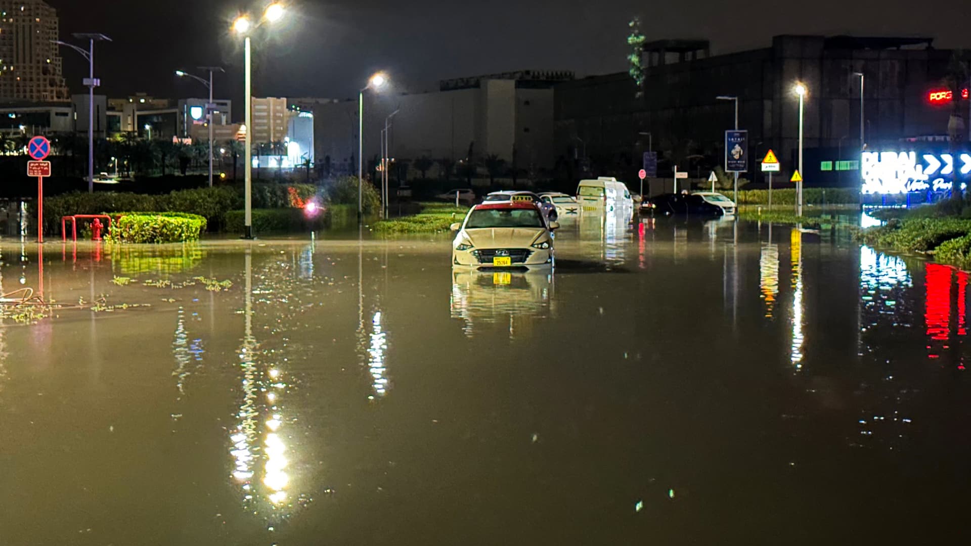 Vehicles are stranded on a flooded street following heavy rains in Dubai early on April 17, 2024. Dubai, the Middle East's financial center, has been paralyzed by the torrential rain that caused floods across the UAE and Bahrain and left 18 dead in Oman on April 14 and 15.
