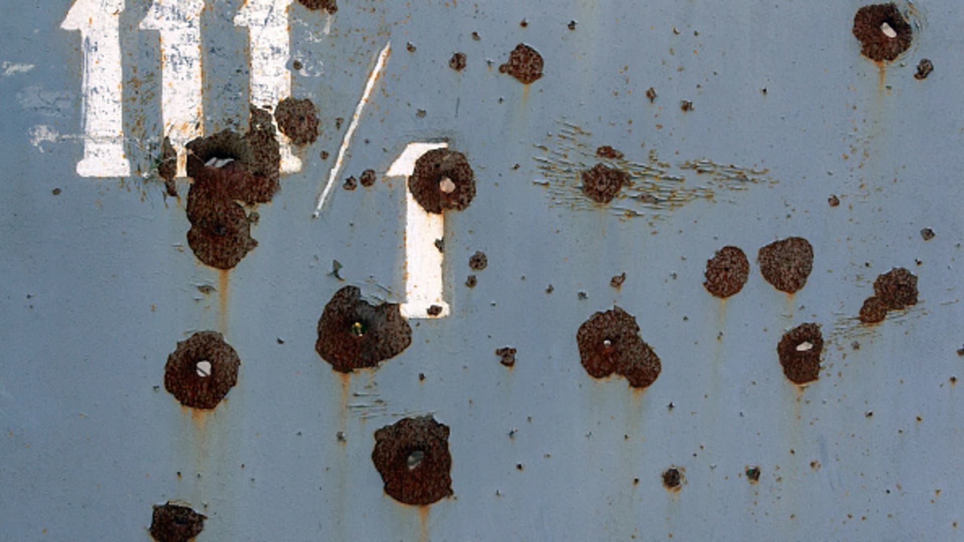 Bullet holes are dotting a metal fence outside a house in the Bobrovytsia neighborhood in Chernihiv, Northern Ukraine, on December 21, 2023. 