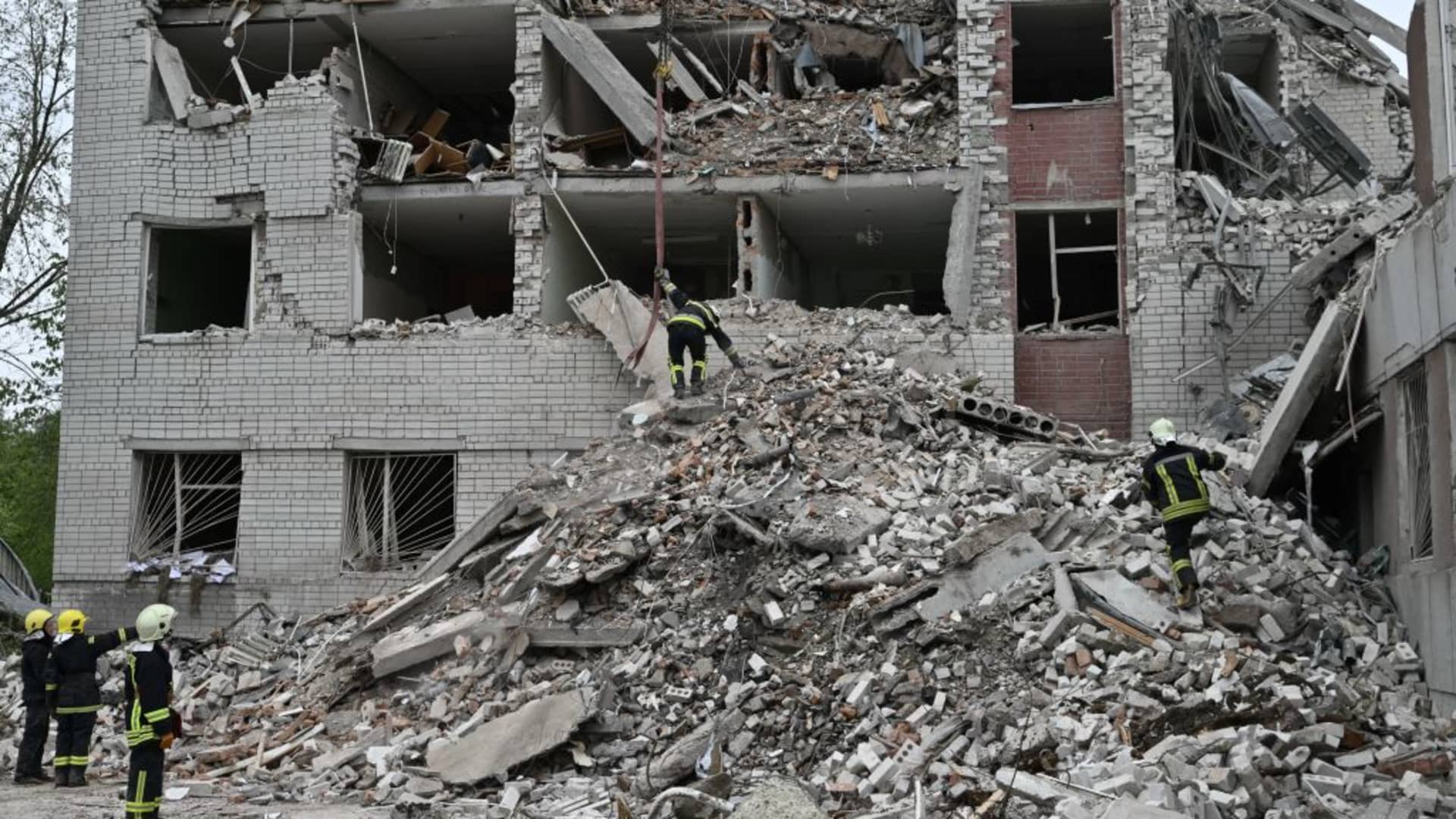 Ukrainian rescuers clear the rubble at a destroyed building following a missile attack in Chernihiv on April 17, 2024. The Russian strike on the historic city in northern Ukraine killed 18 people and wounded dozens more on April 17, 2024, as Kyiv pleaded for allies to bolster its over-stretched air defence systems. 