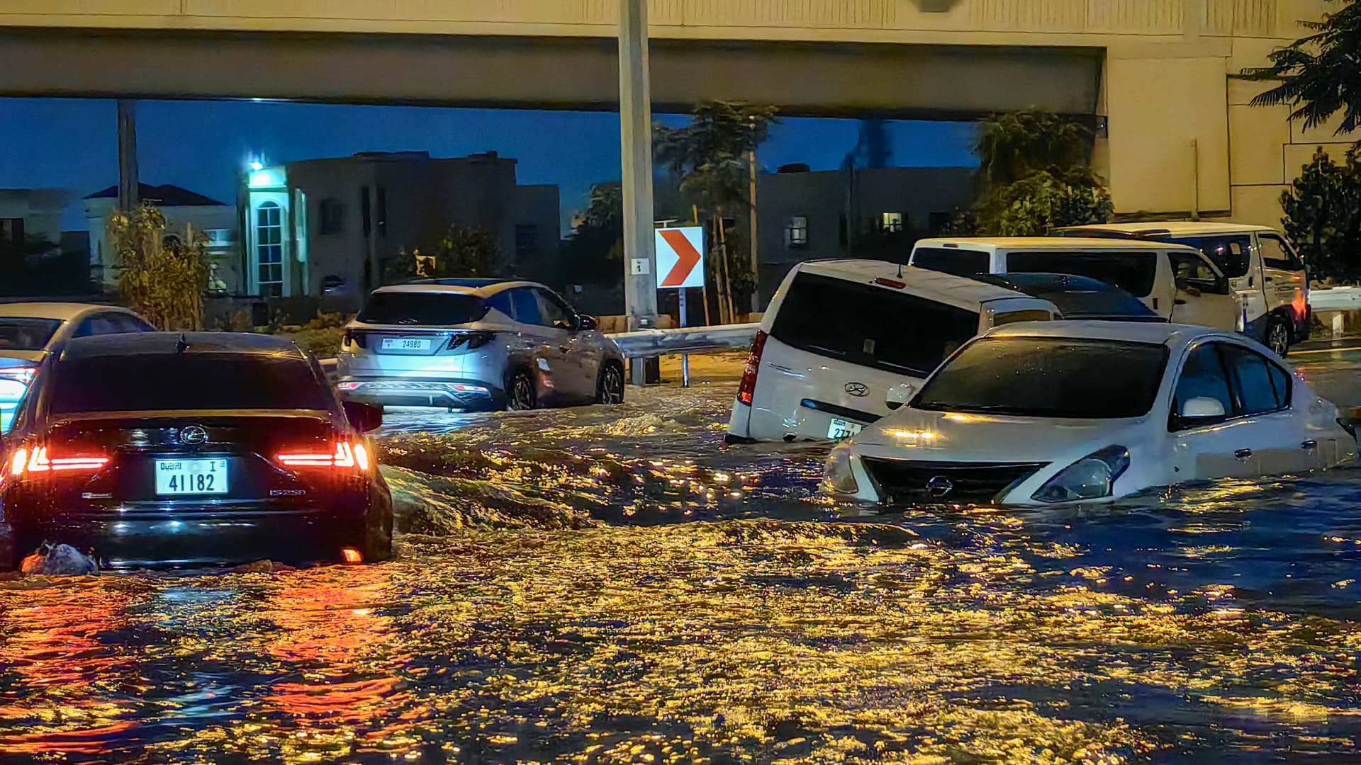 Cars drive in a flooded street following heavy rains in Dubai on April 17, 2024.