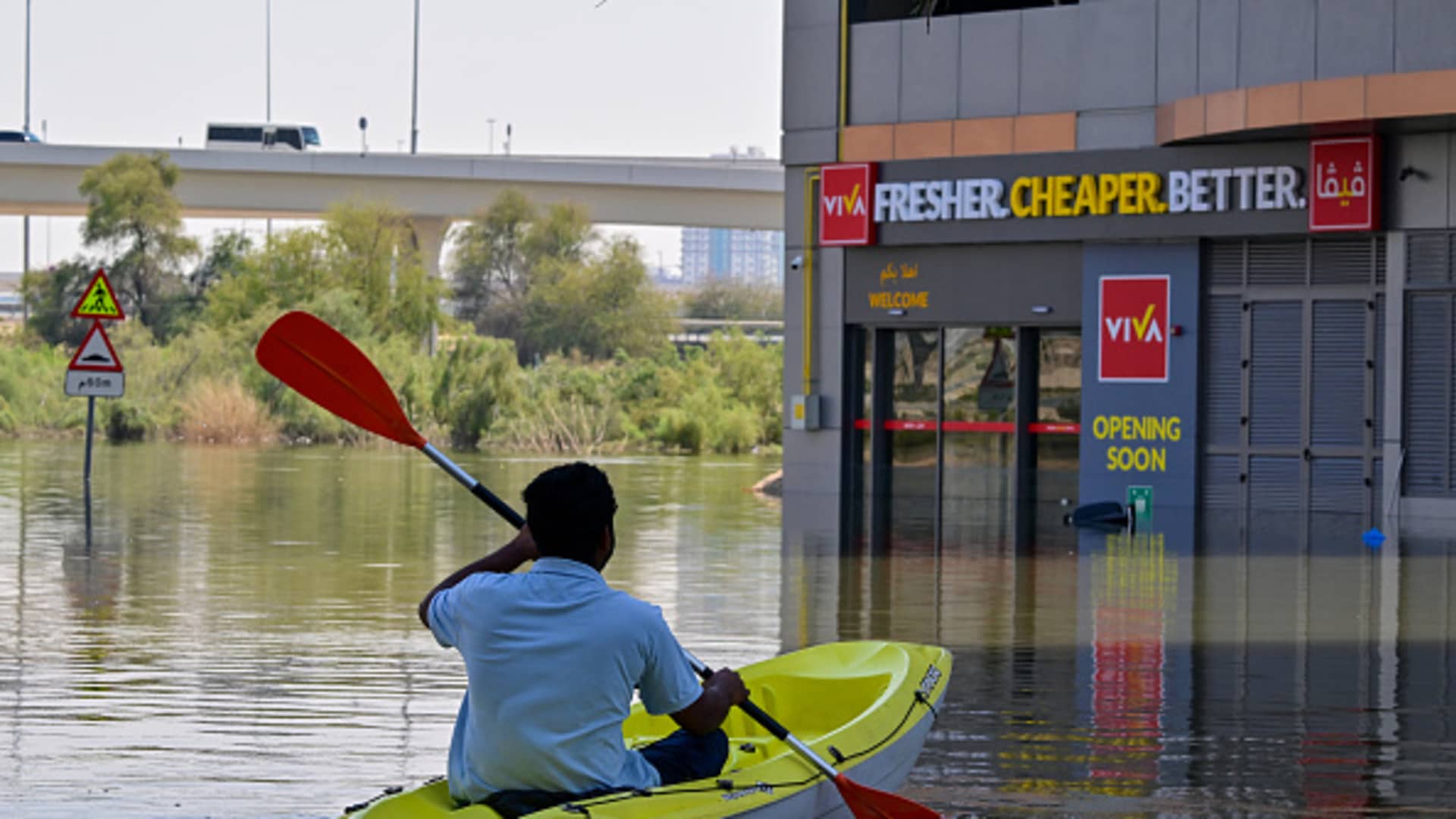 A man steers his canoe on a flooded street in Dubai following heavy rains on April 18, 2024. Dubai's giant highways were clogged by flooding and its major airport was in chaos as the Middle East financial center remained gridlocked on April 18, a day after the heaviest rains on record. 