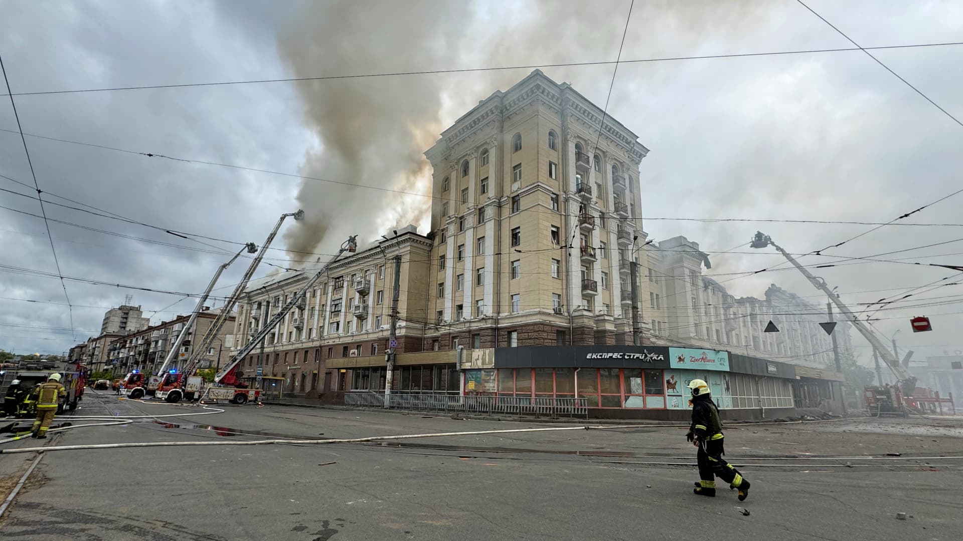 Ukrainian rescuers try to extinguish a fire in a residential building following a missile attack in Dnipro on April 19, 2024, amid the Russian invasion of Ukraine. Russian strikes overnight killed eight people, including two children, and injured 18 in Ukraine's central Dnipropetrovsk region, the interior ministry said on April 19, 2024, updating the toll.