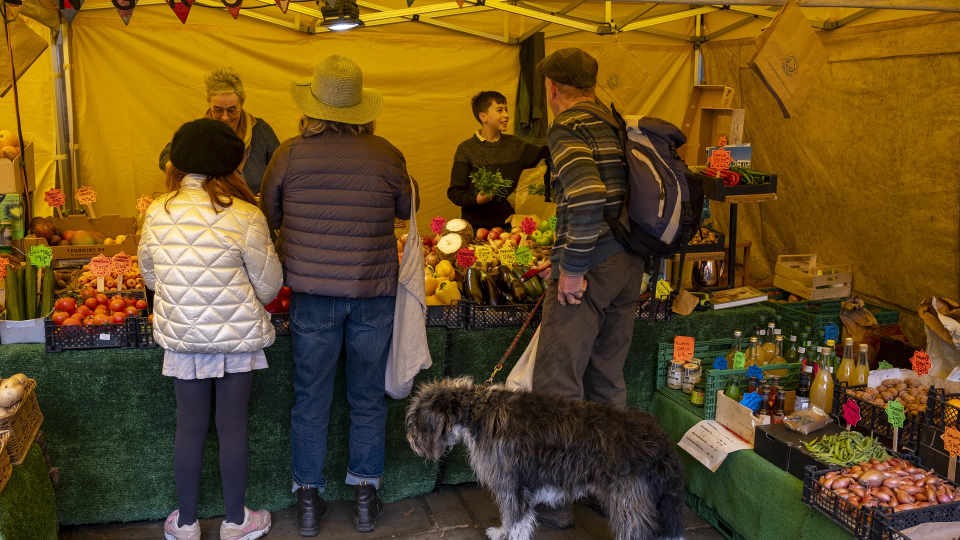 People buying vegatables from a fruit and veg stall at Stroud Farmers Market on 30th March 2024 in Stroud, United Kingdom. 