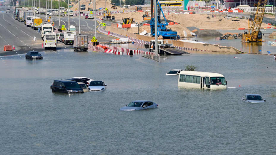 TOPSHOT - Cars are stranded on a flooded street in Dubai following heavy rains on April 18, 2024. Dubai's giant highways were clogged by flooding and its major airport was in chaos as the Middle East financial centre remained gridlocked on April 18, a day after the heaviest rains on record. (Photo by Giuseppe CACACE / AFP) (Photo by GIUSEPPE CACACE/AFP via Getty Images)