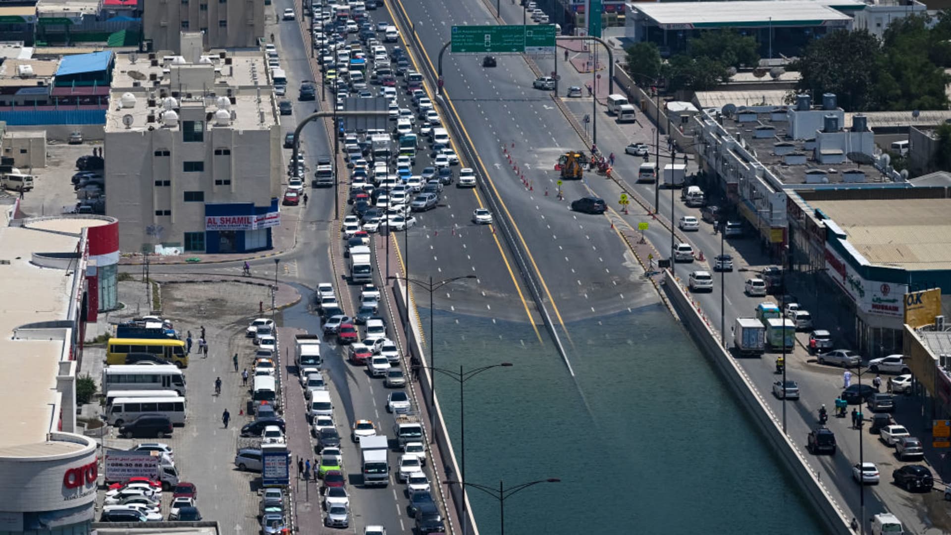 Traffic is diverted from a flooded street in Sharjah on April 20, 2024, following the UAE's heaviest rainfall on record.