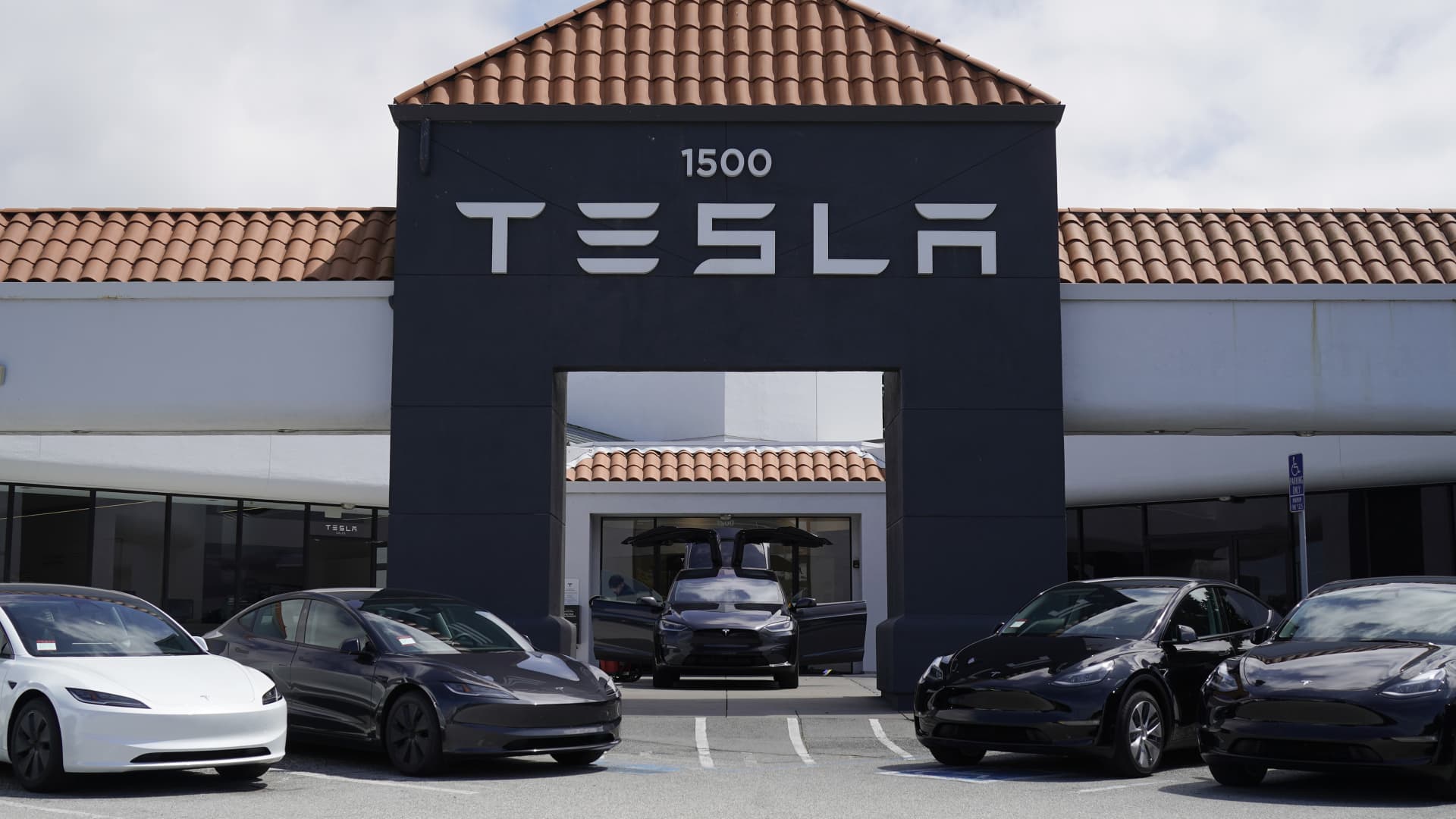 New Tesla electric vehicles are parked outside a Tesla store on April 15, 2024 in San Mateo County, California. 