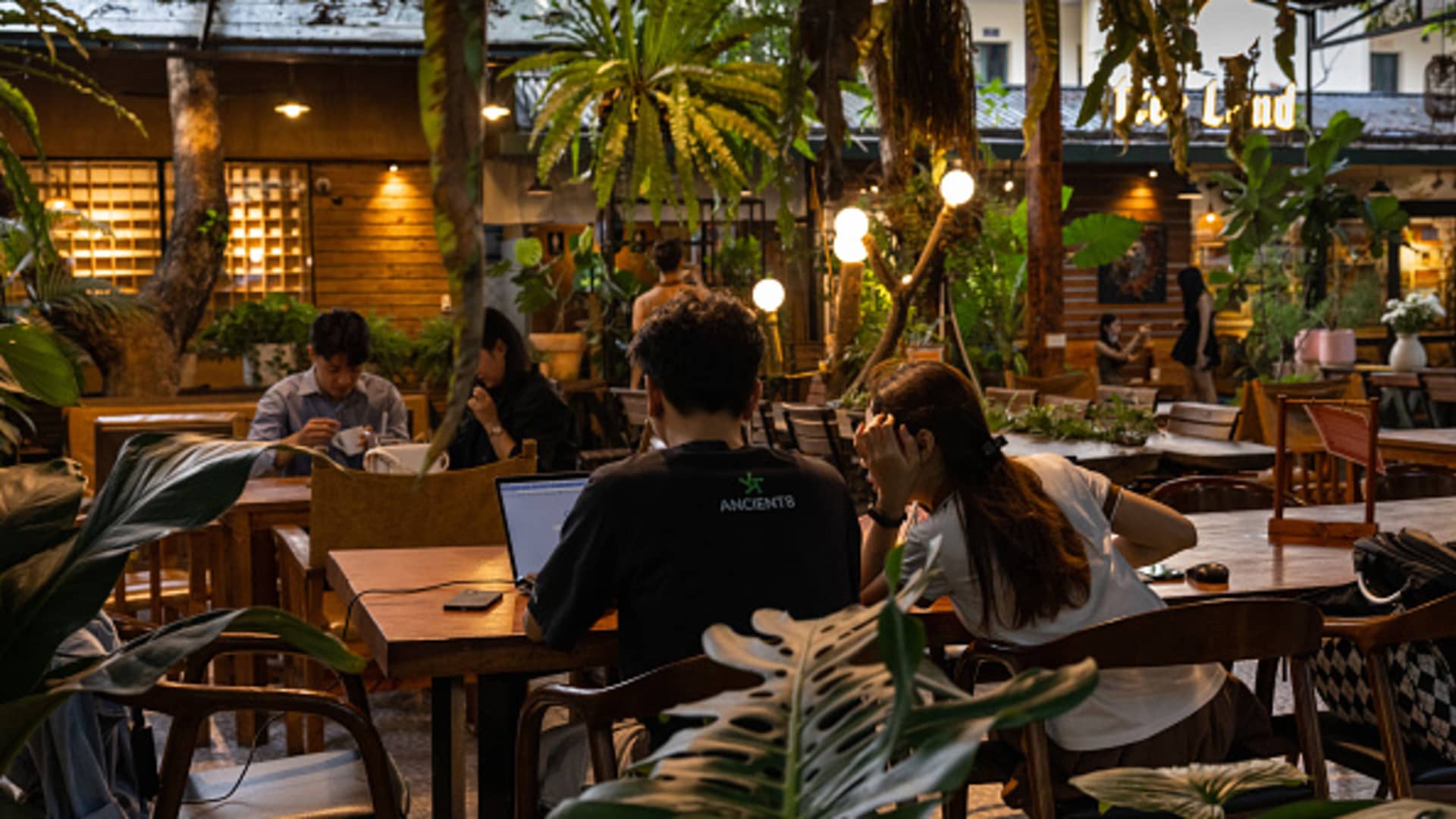 Customers work a cafe and a co-working space in Hanoi, Vietnam, on Thursday, July 20, 2023. 