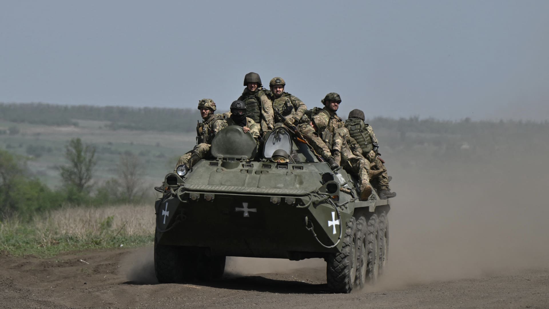 Ukrainian servicemen ride on an armored personnel carrier in a field near Chasiv Yar, Donetsk, on April 27, 2024, amid the Russian invasion of Ukraine. 
