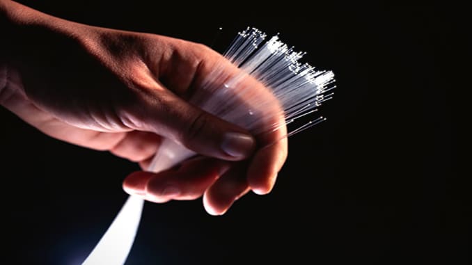 The science behind fiber optics has been studied since the 1800s, but it wasn't until the 1970s that the quality of optical fibers improved enough to allow its use in communication applications. Fiber optics quickly became the preferred medium for telecommunication and networking because the cables can span long distances with few repeaters and carry signals at rates over 100 gigabytes per second. The relative importance of fiber optic technology is evidenced by its speed and effectiveness in sh