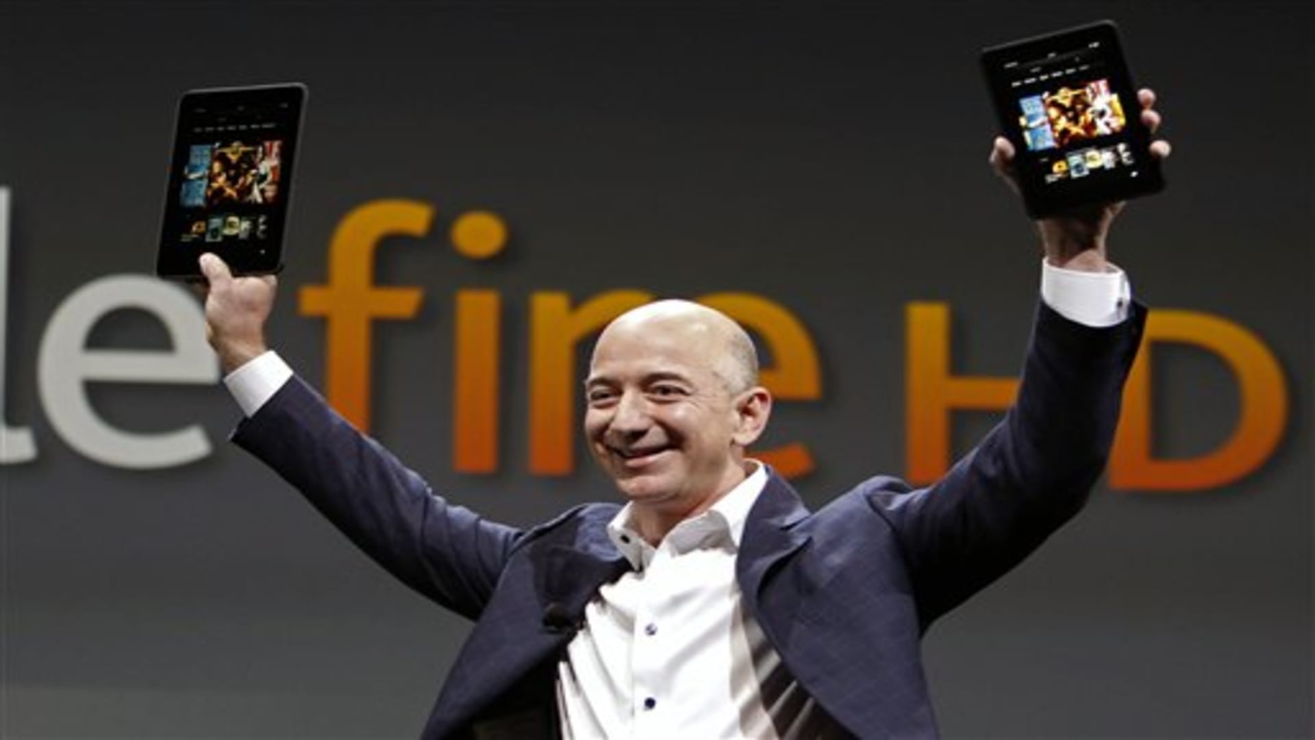 Jeff Bezos, CEO and founder of Amazon, holds the new Amazon Kindle Fire HD at the product's introduction in Santa Monica, Calif., Thursday, Sept. 6, 2012. (AP Photo/Reed Saxon)